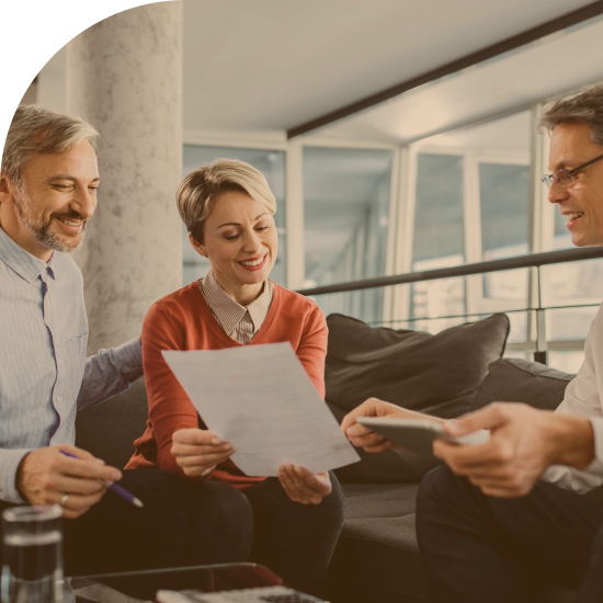 Happy couple financial advisor going through plans during meeting